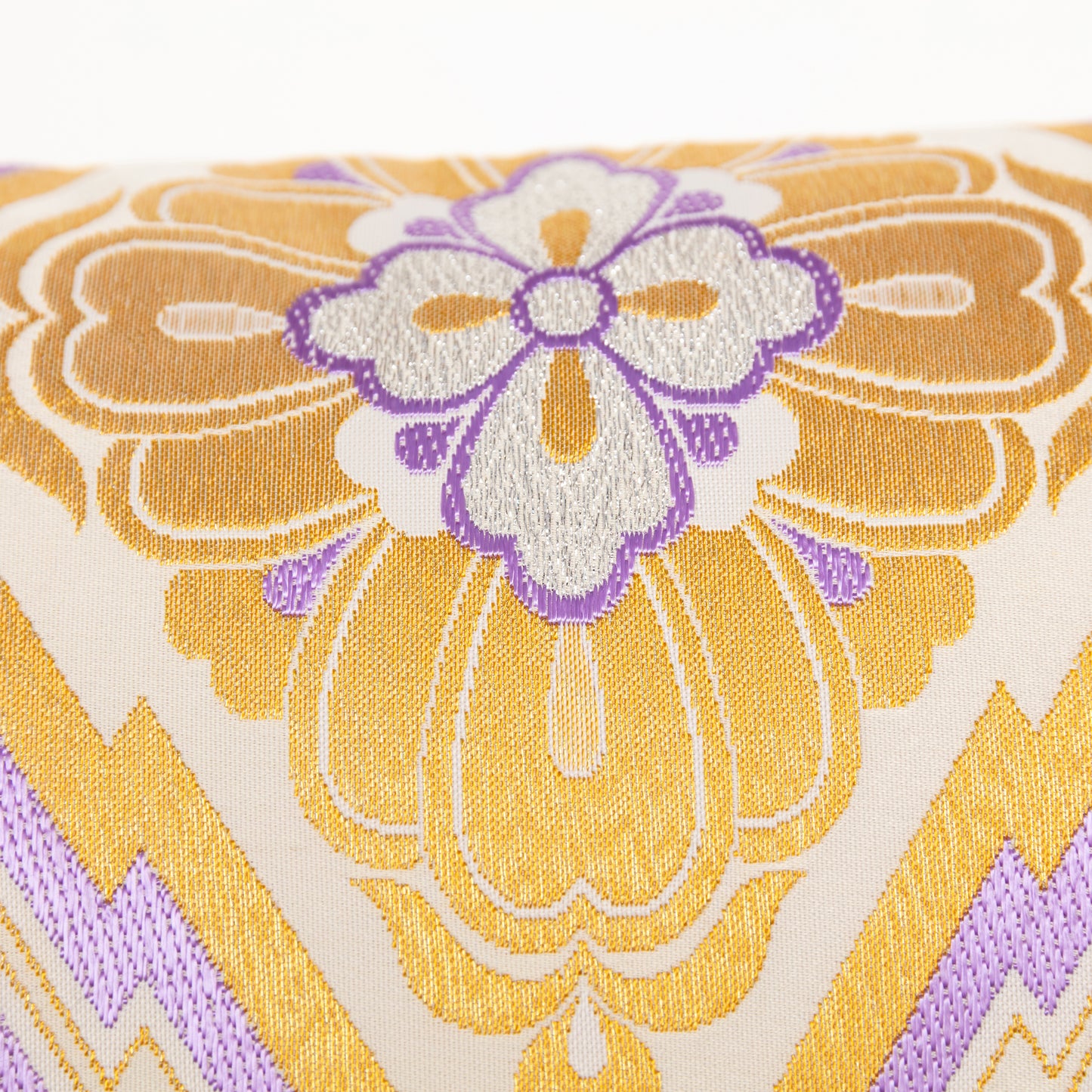 Gold and cream silk pillow, detail of purple embroidery flower.