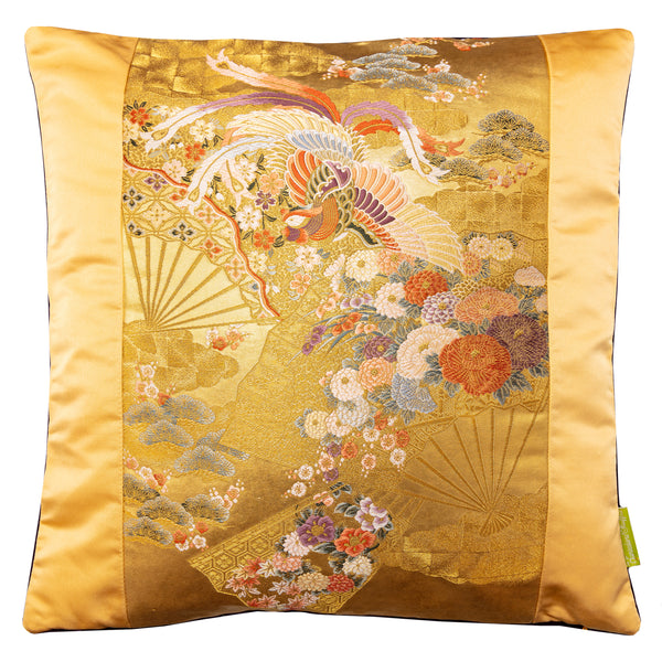 Square gold silk pillow on white background. A golden silk panel each side, central panel is decorative vintage obi silk with flower, fans and flying phoenix design.