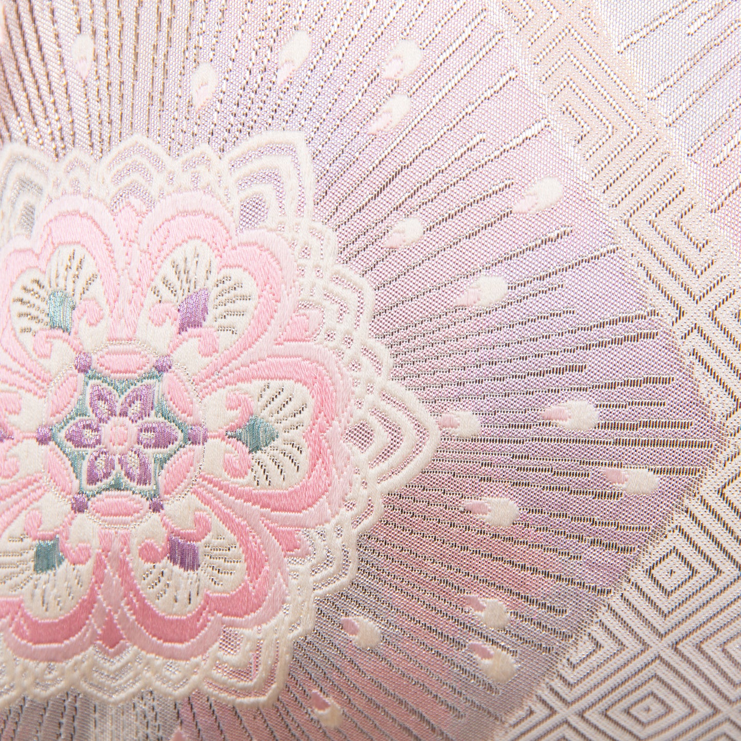 Detail of pink silk obi pillow with silver, cream and pale blue accents.