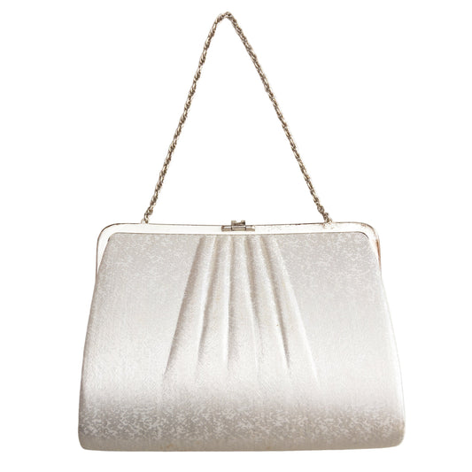 Silver glittery handbag with a chain strap on a white background