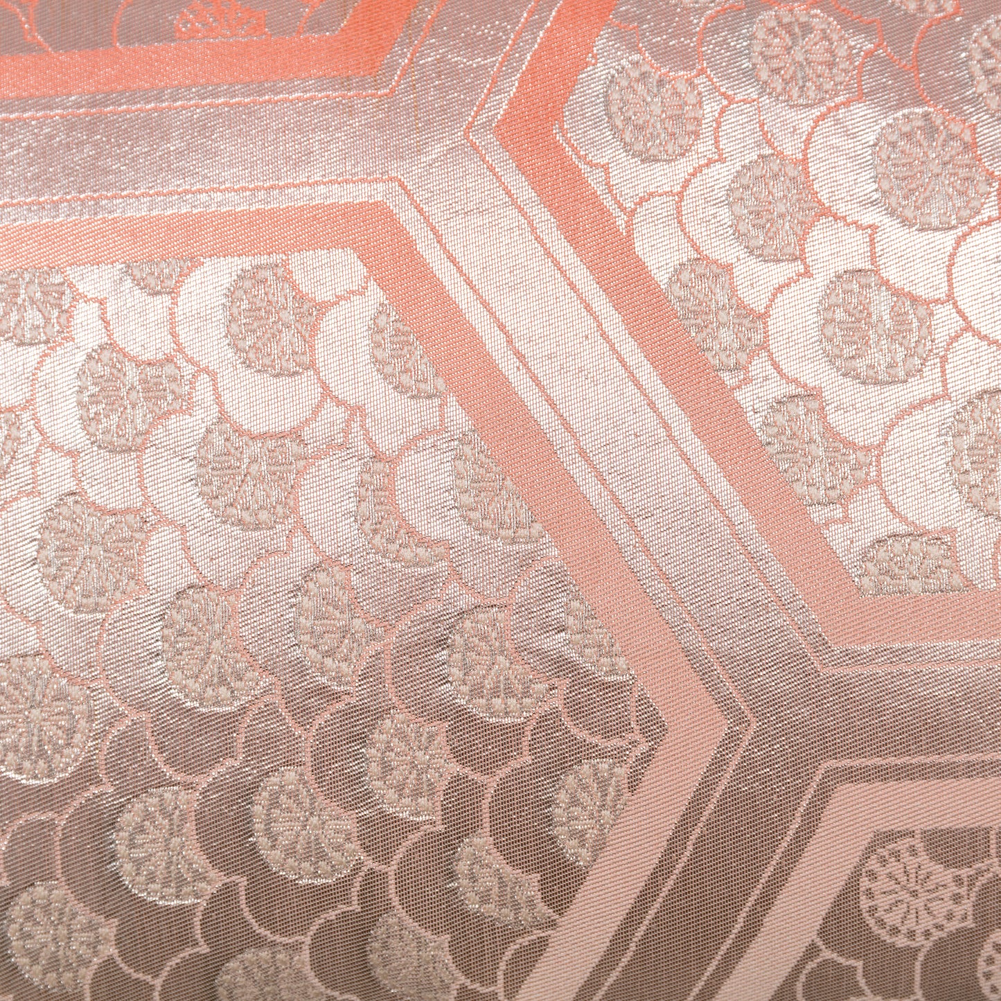 Detail of silver Obi pillow with peach hexagons and plum blossom pattern.
