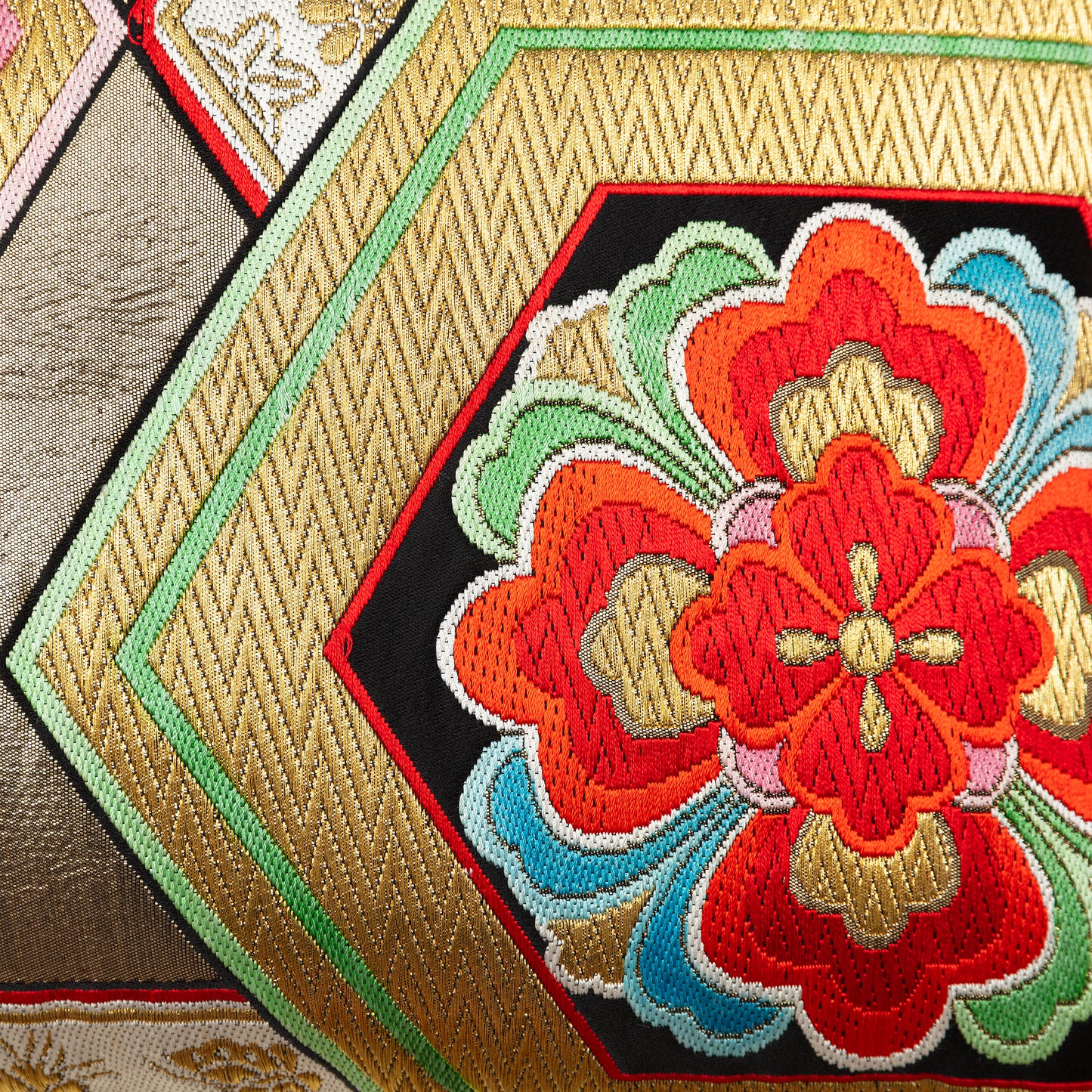 Detail of gold obi cushion with red flower
