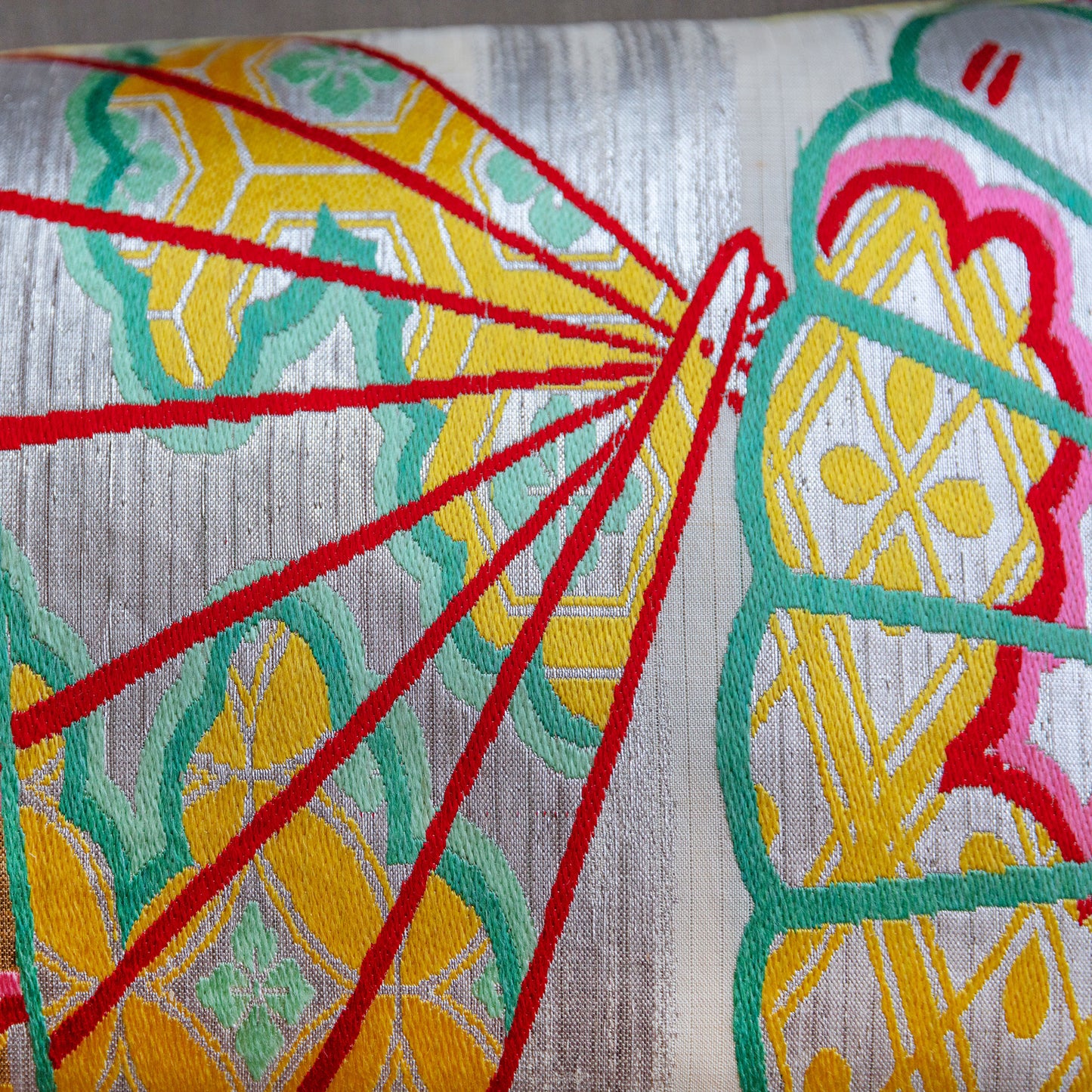 Detail of red fans on silver obi silk pillow by Hunted and Stuffed