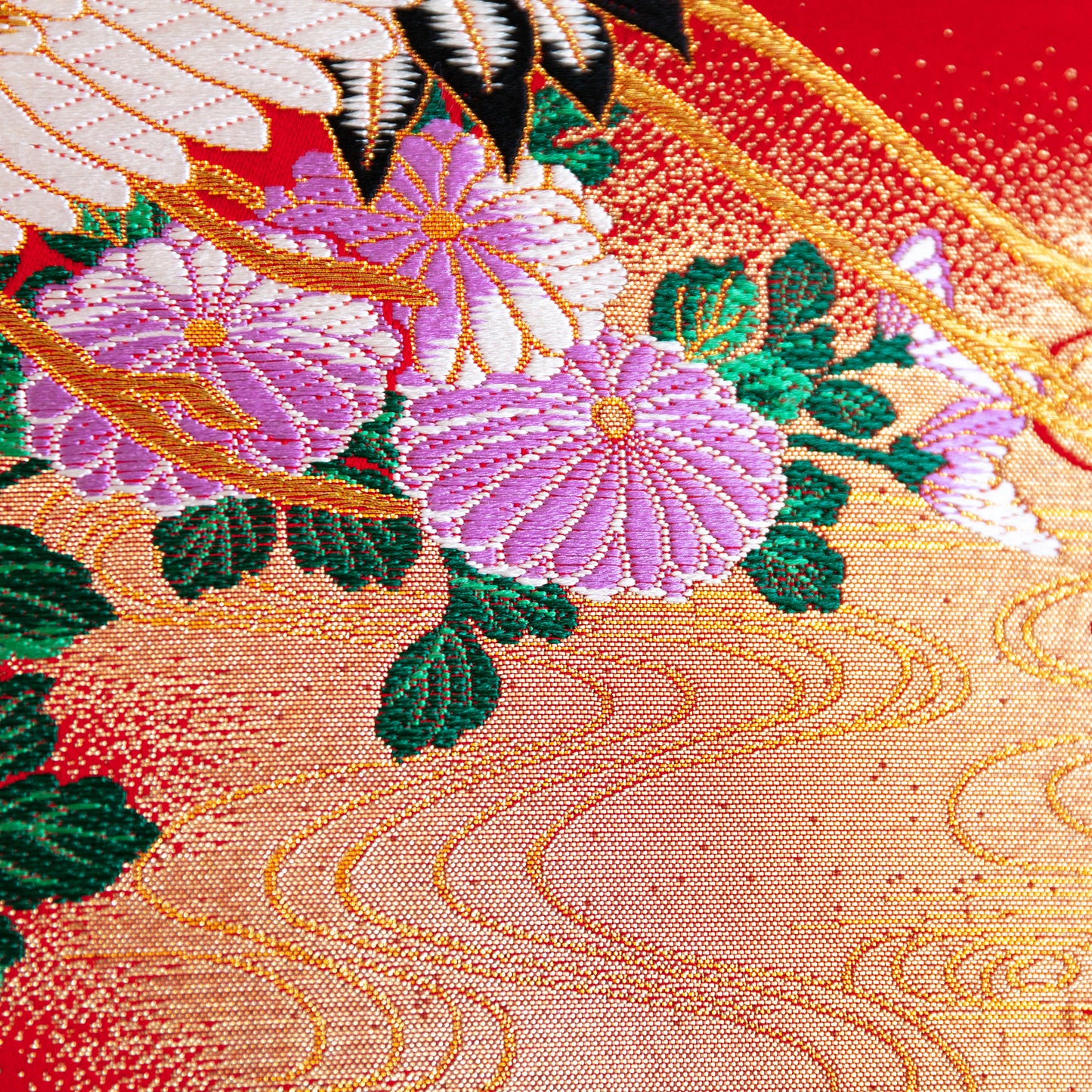 detail of purple flowers over gold and red silk base, part of an obi cushion by hunted and stuffed