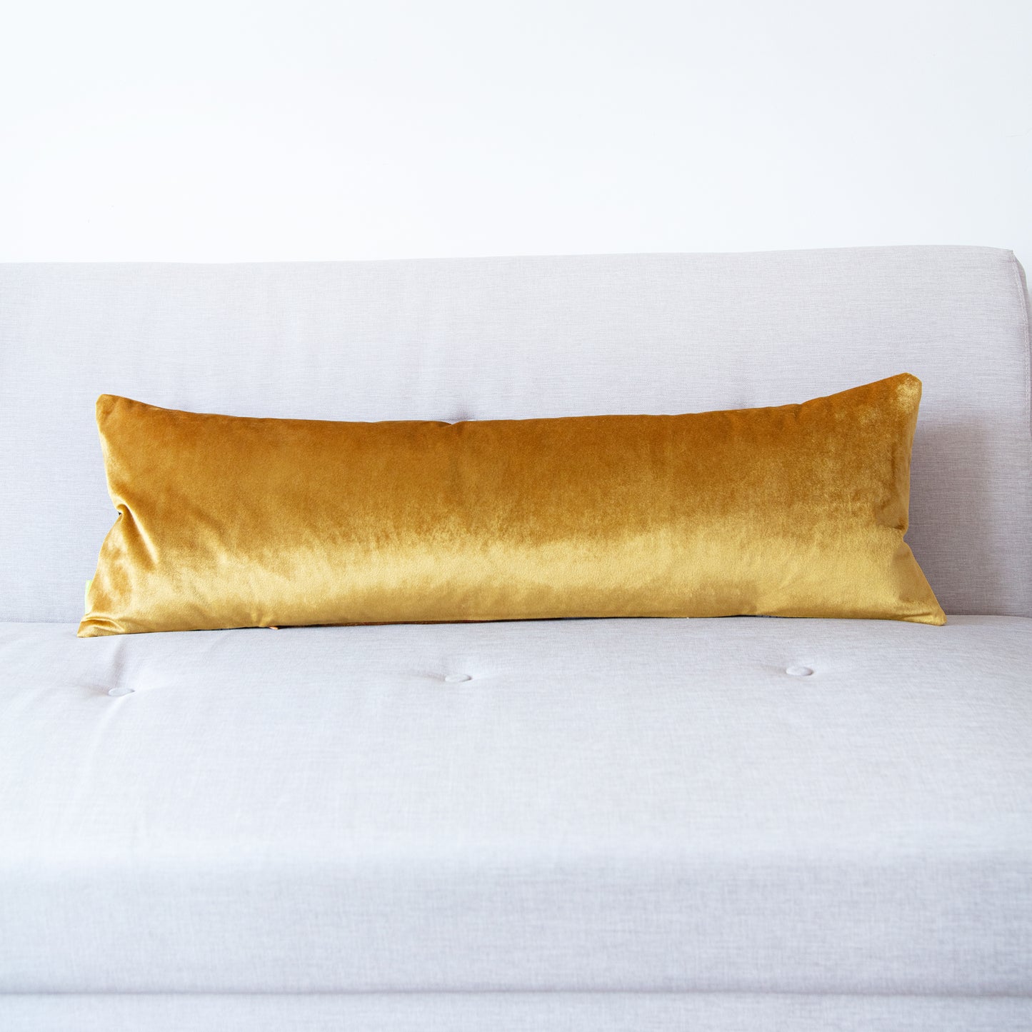 Long bolster pillow with gold velvet reverse
