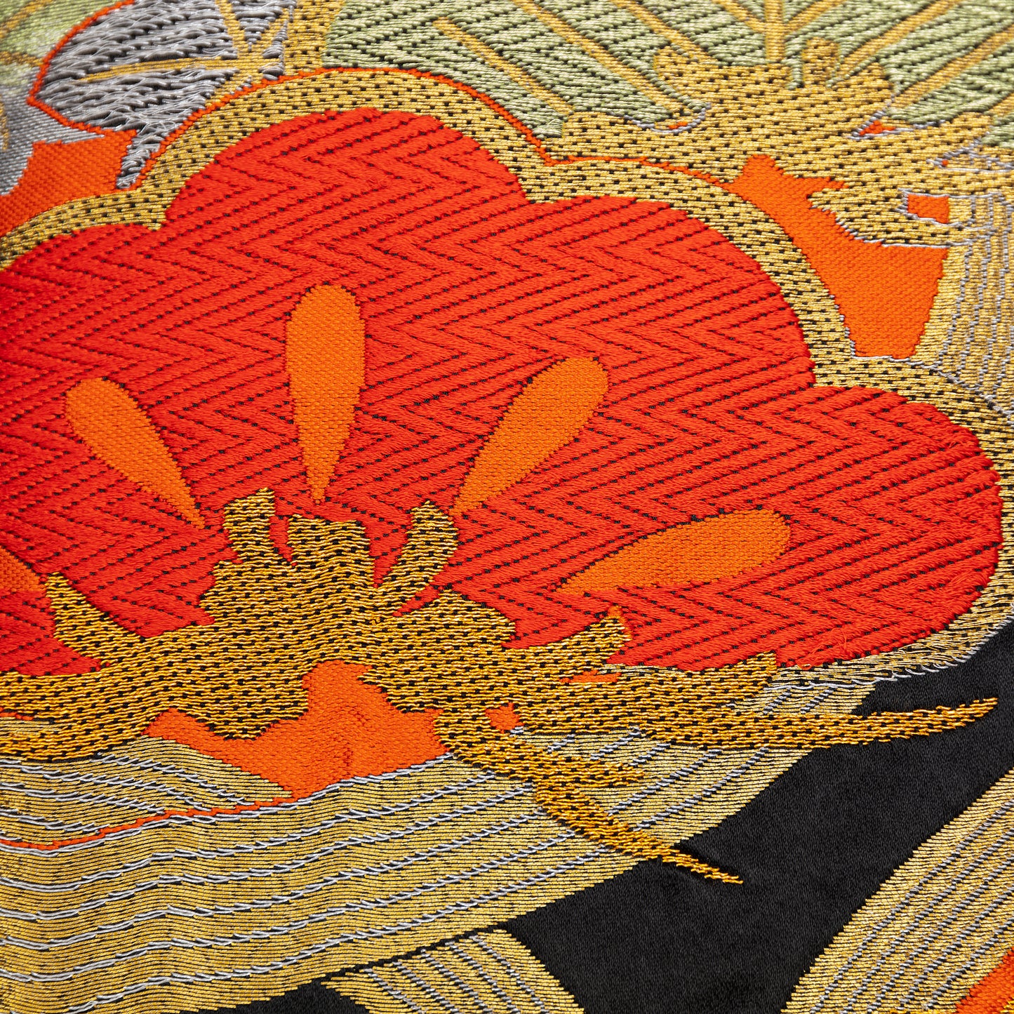 Detail of stylised pine (matsu) in red silk thread with metallic gold accents over black silk. Upcycled vintage obi.