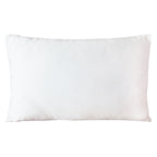 Close-up of plush silk fabric showcasing intricate peacock feather embroidery and subtle pink sheen detail on the cushion's