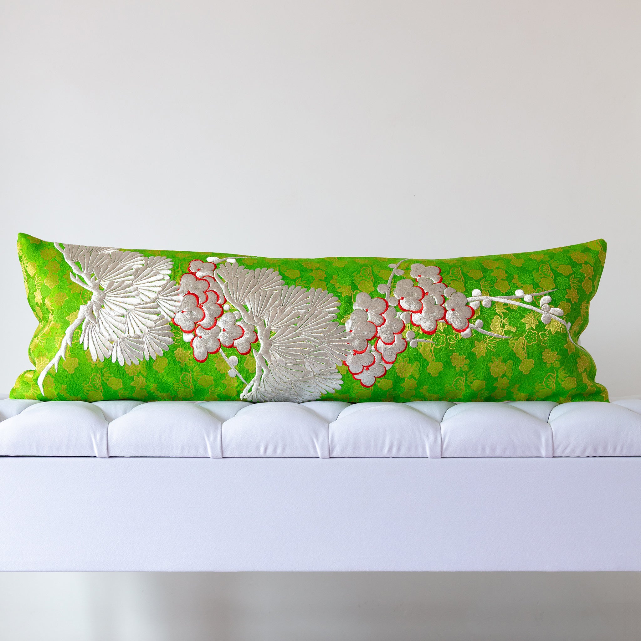 Green silk kimono bolster cushion with white pine and blossom embroidery on metallic patterned silk