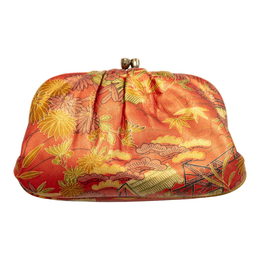 Orange leather vintage Japanese clutch bag with floral pattern on a white background