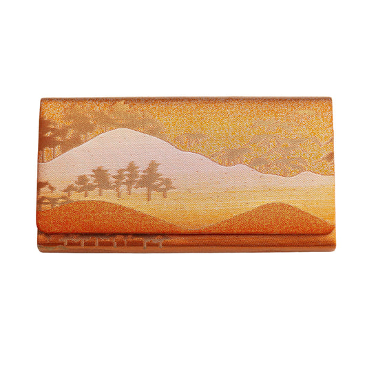 Metallic silk clutch bag with a scenic design of mountains and trees on a white background