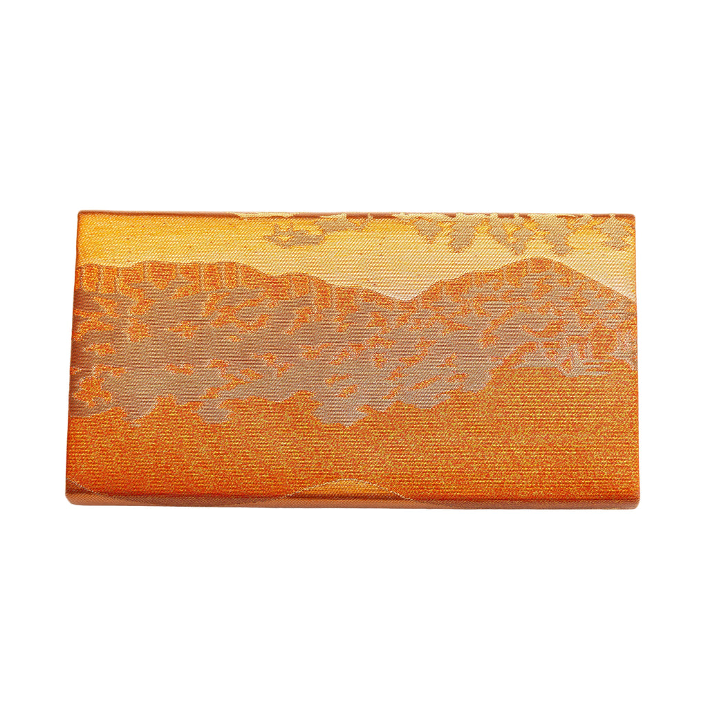 Close-up of bronze silk envelope clutch displaying the intricate textured landscape scene and subtle metallic sheen.