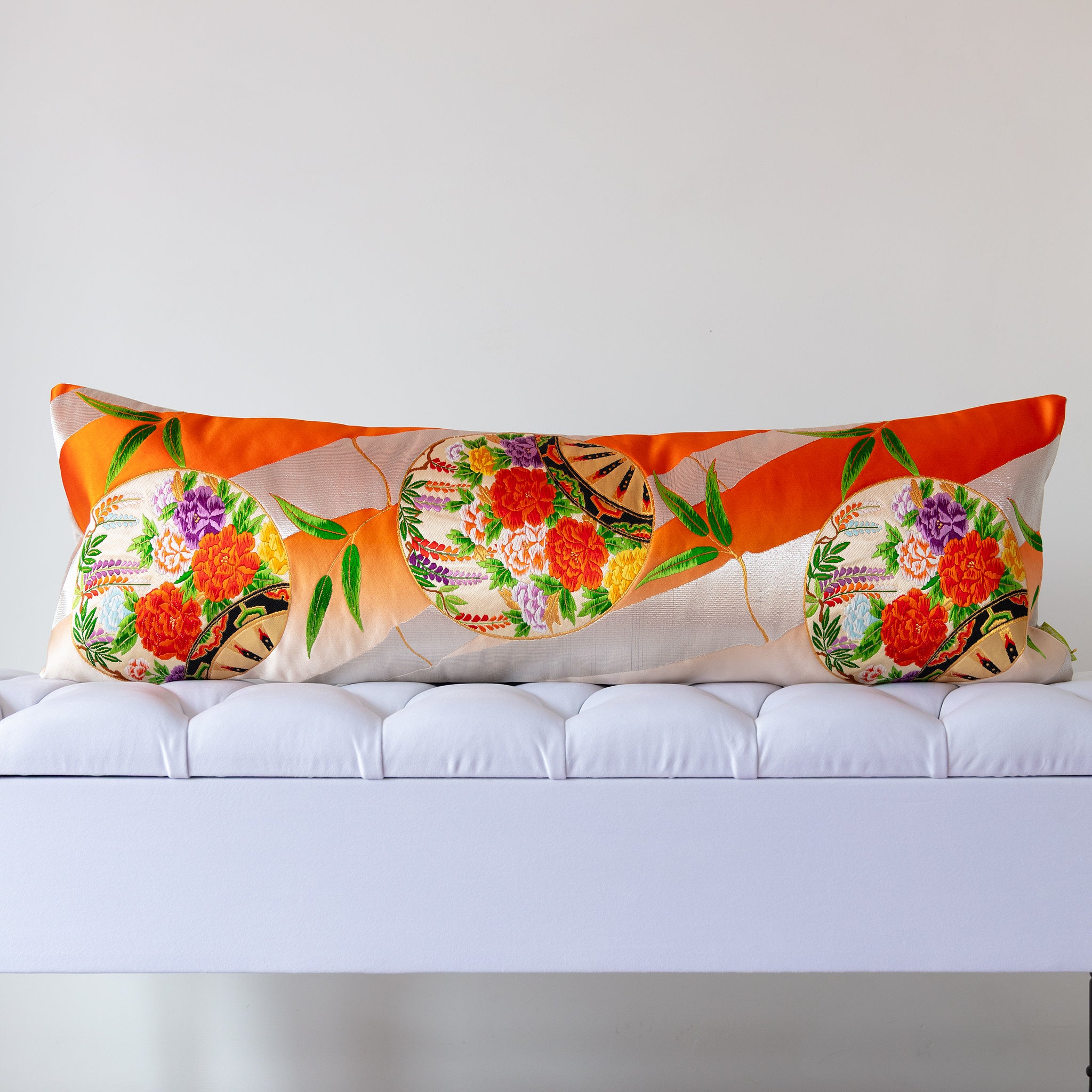 Orange ombré silk kimono bolster cushion with floral medallions and bamboo leaves, crafted from vintage Japanese silk