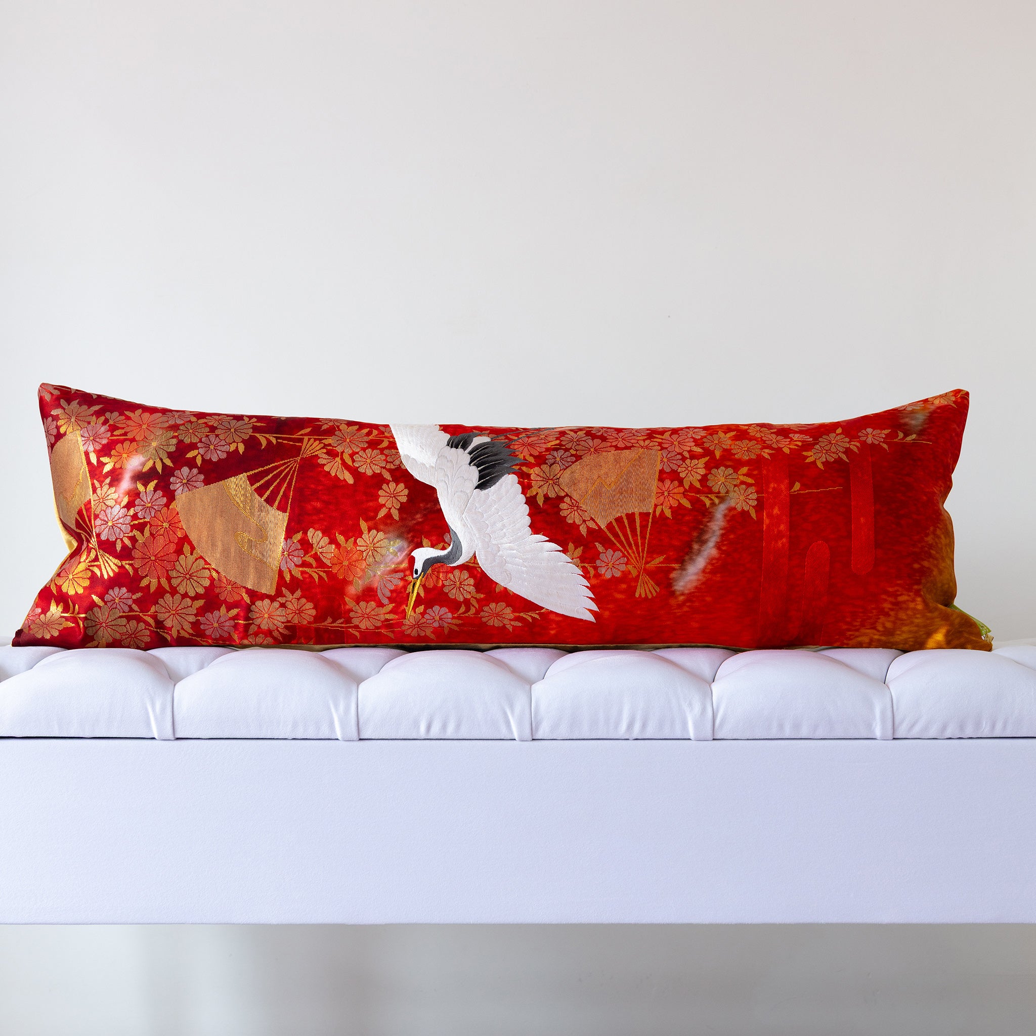 Red silk kimono bolster cushion with white crane and gold fan motifs, crafted from vintage Japanese silk
