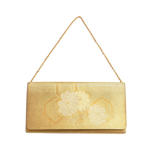 Gold clutch bag with floral design on a white background