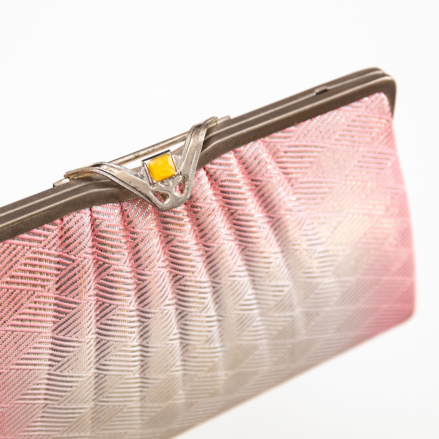 Pink and silver ombre vintage silk clutch bag with a decorative clasp on a white background