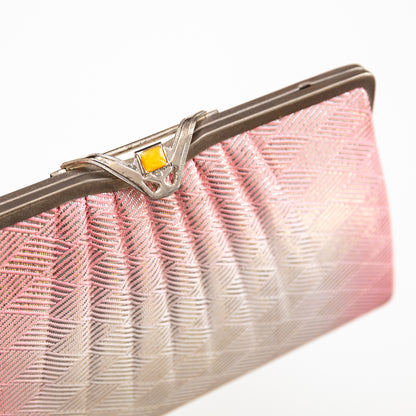Pink and silver ombre vintage silk clutch bag with a decorative clasp on a white background