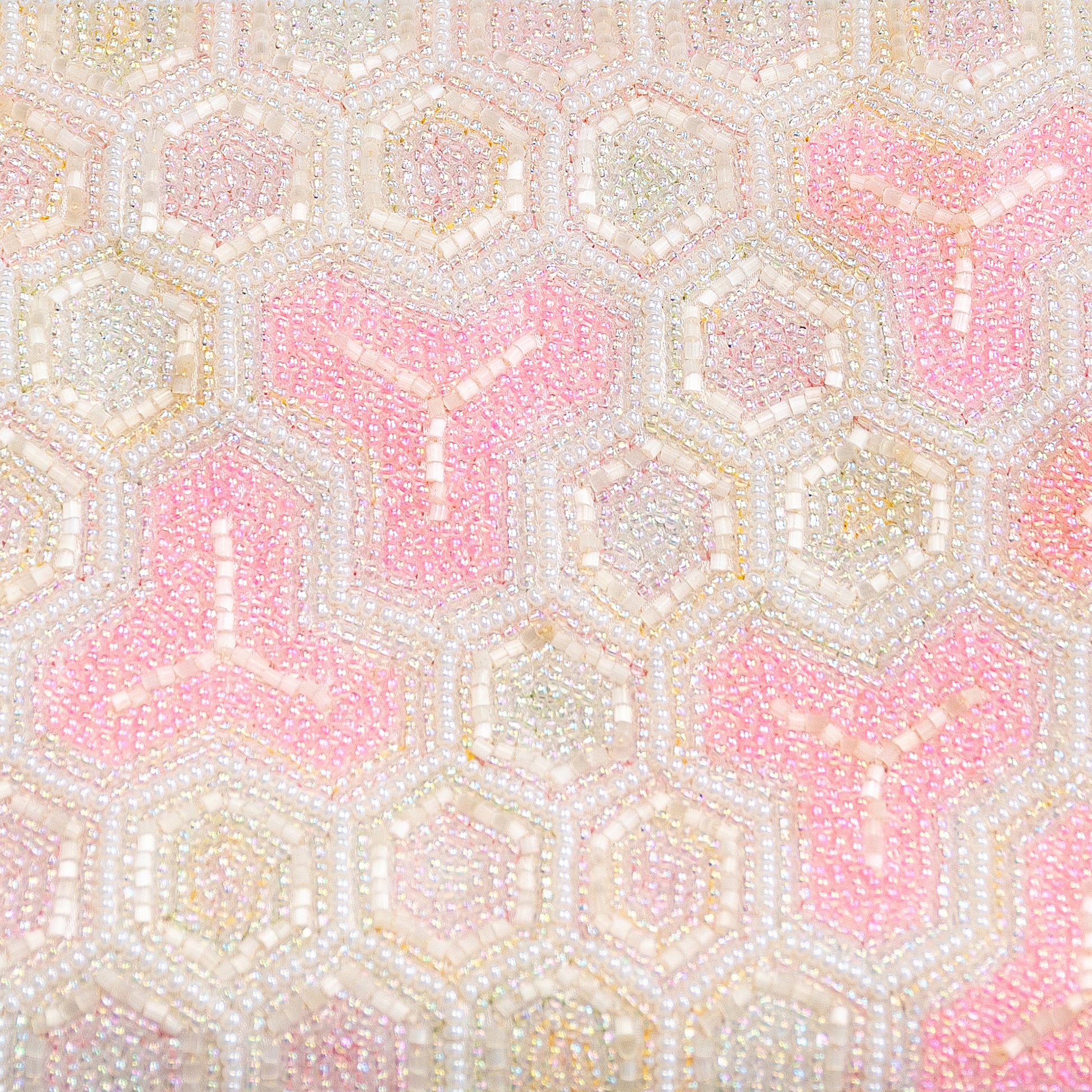 Hexagonal pattern beaded bag close up of beading with lots of tiny pink and white beads making bishamonten kikko pattern.