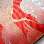 Close-up of the vibrant red silk fabric showcasing intricate crane embroidery and subtle velvet sheen detail.