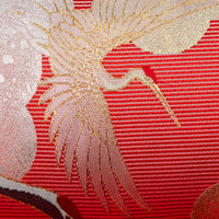 Detail of a crane woven in gold silk thread.