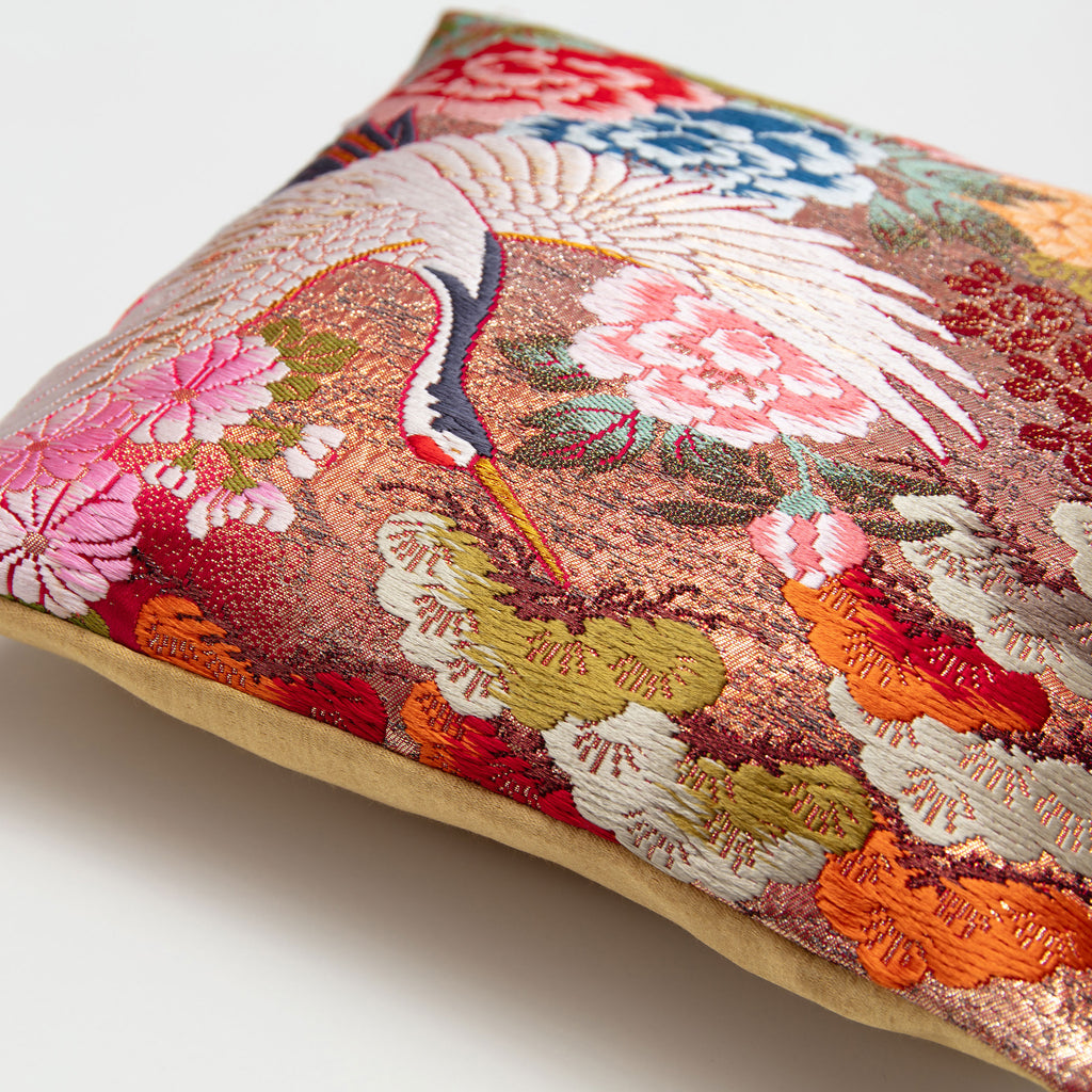 Angled detail of a Crane (Tsuru) uchikake silk cushion cover showing metallic weave and gold satin reverse.
