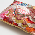 Angled detail of a Crane (Tsuru) uchikake silk cushion cover showing metallic weave and gold satin reverse.