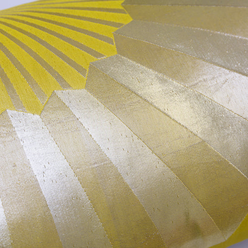 Close-up of the pillow's golden fan pattern stitched onto chartreuse silk, highlighting intricate embroidery and rich
