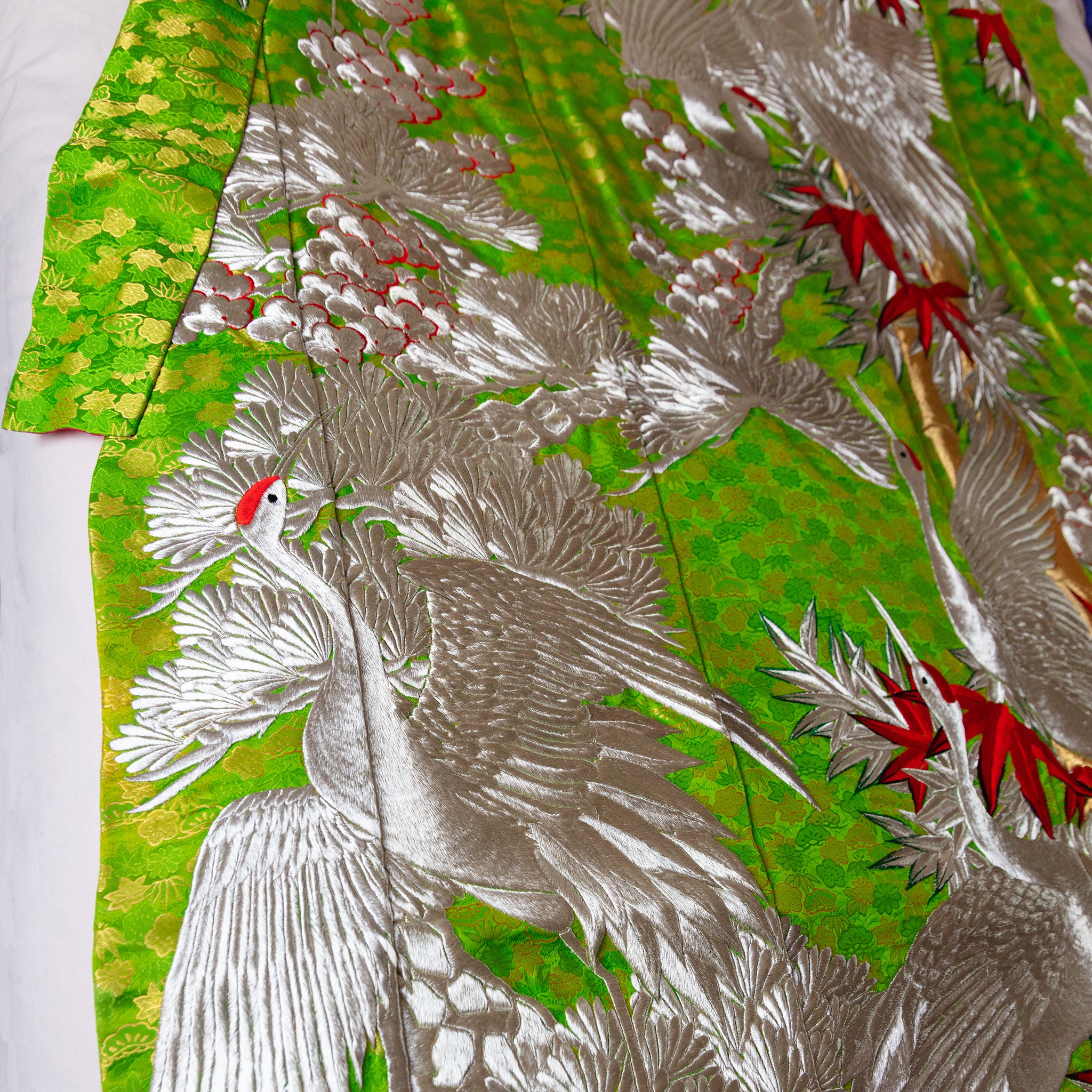 Close-up of intricate silk weave and hand-stitched edges highlighting craftsmanship detail on the vintage kimono blanket.