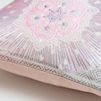 Close-up of the pink ombre silk fabric showcasing silver floral hexagon embroidery and textured stripe details on the Obi