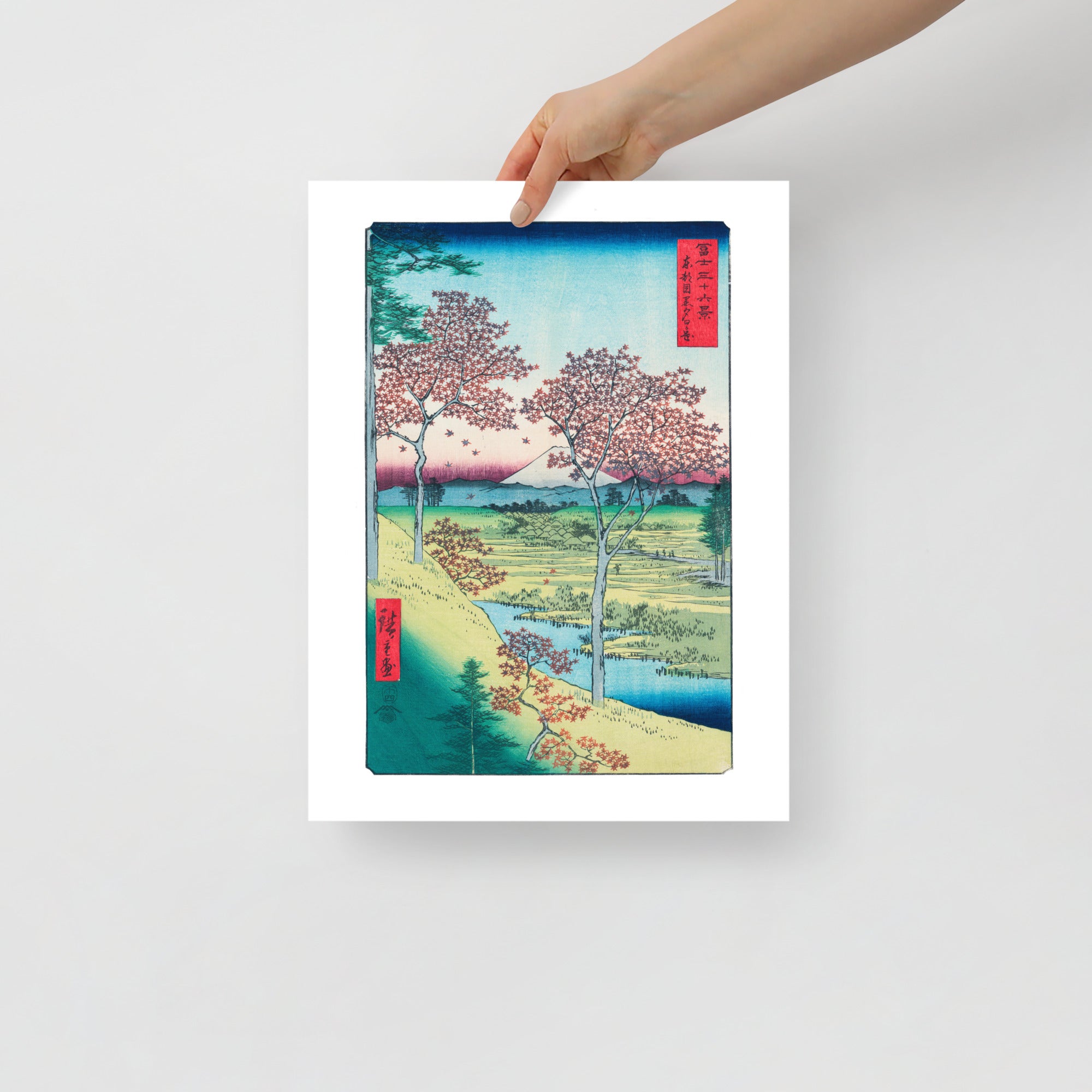 Close-up of vibrant sunset hues illuminating the detailed maple leaves and textured woodblock surface from a diagonal