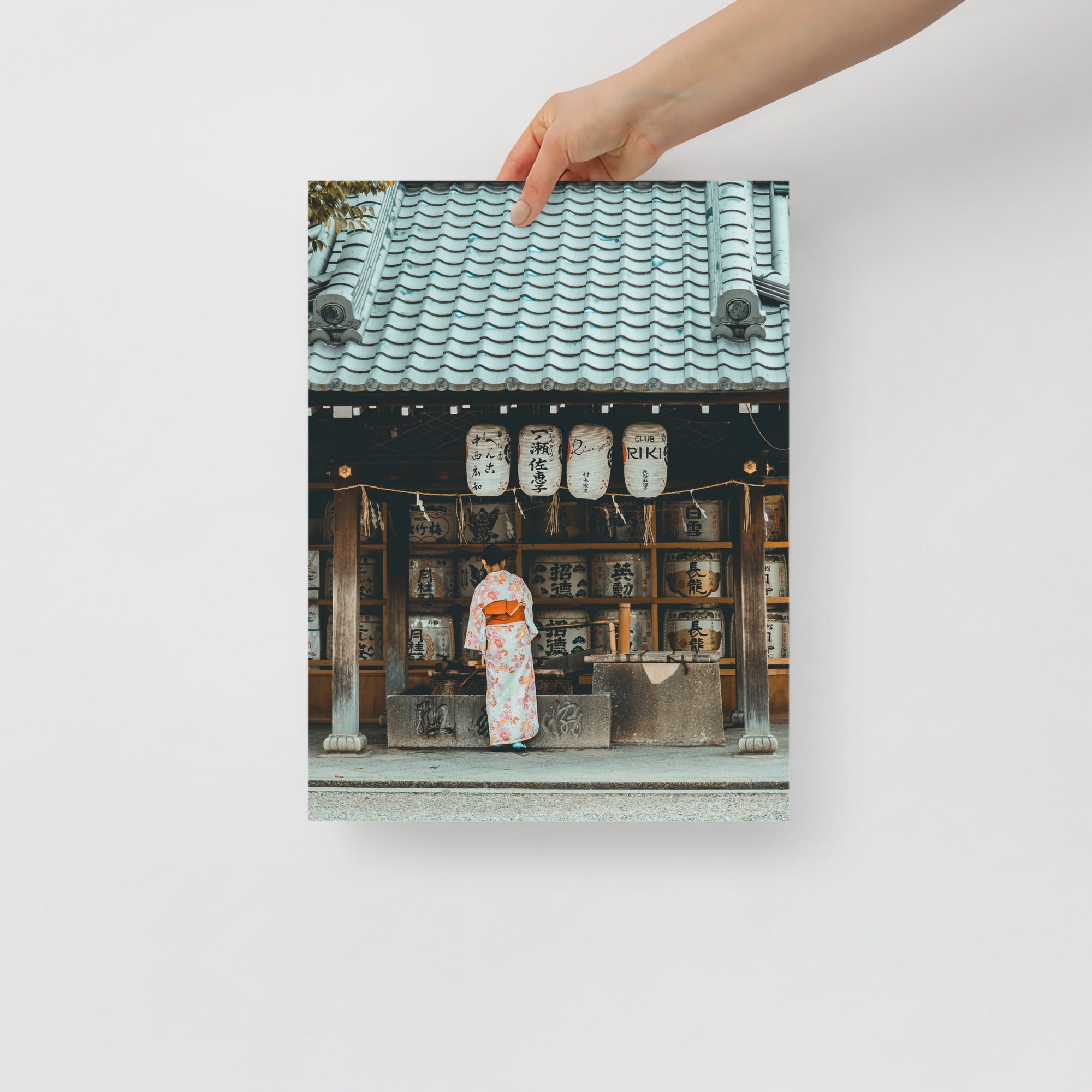 Close-up of intricate kimono fabric featuring delicate cherry blossom and wave motifs with textured embroidery detail