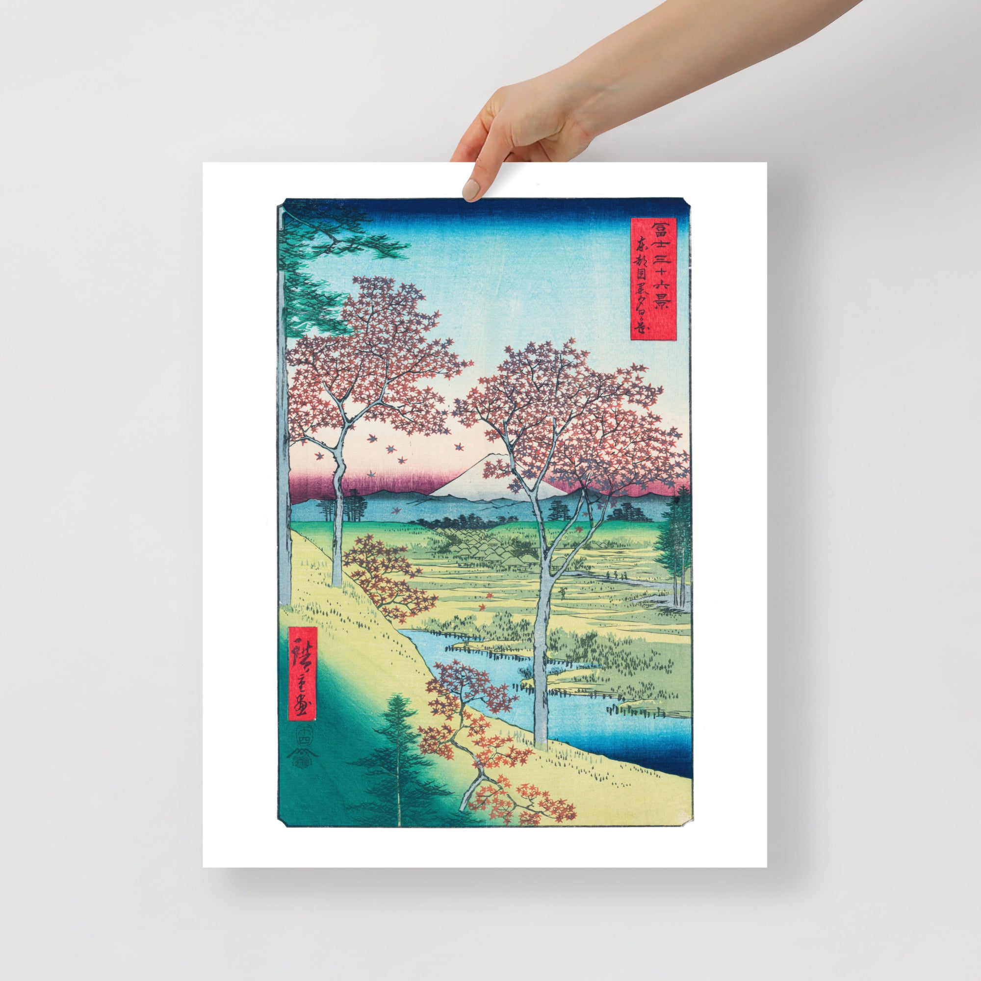 Detail of vibrant sunset hues and intricate maple leaf textures on the Hiroshige woodblock print, viewed from a diagonal