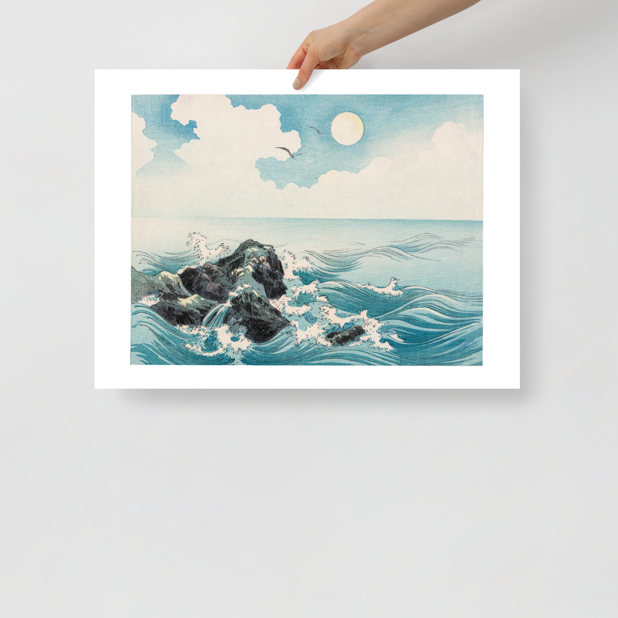 Close-up of textured woodgrain and bold ink strokes highlighting crashing waves on the rocks in this Japanese woodcut print