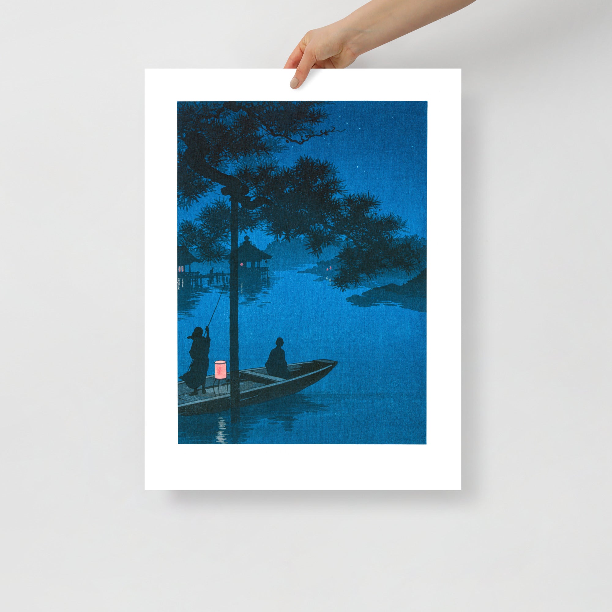 Detail of cherry blossom branches illuminated beneath moonlight in the nighttime scene, showing delicate ink stroke texture.