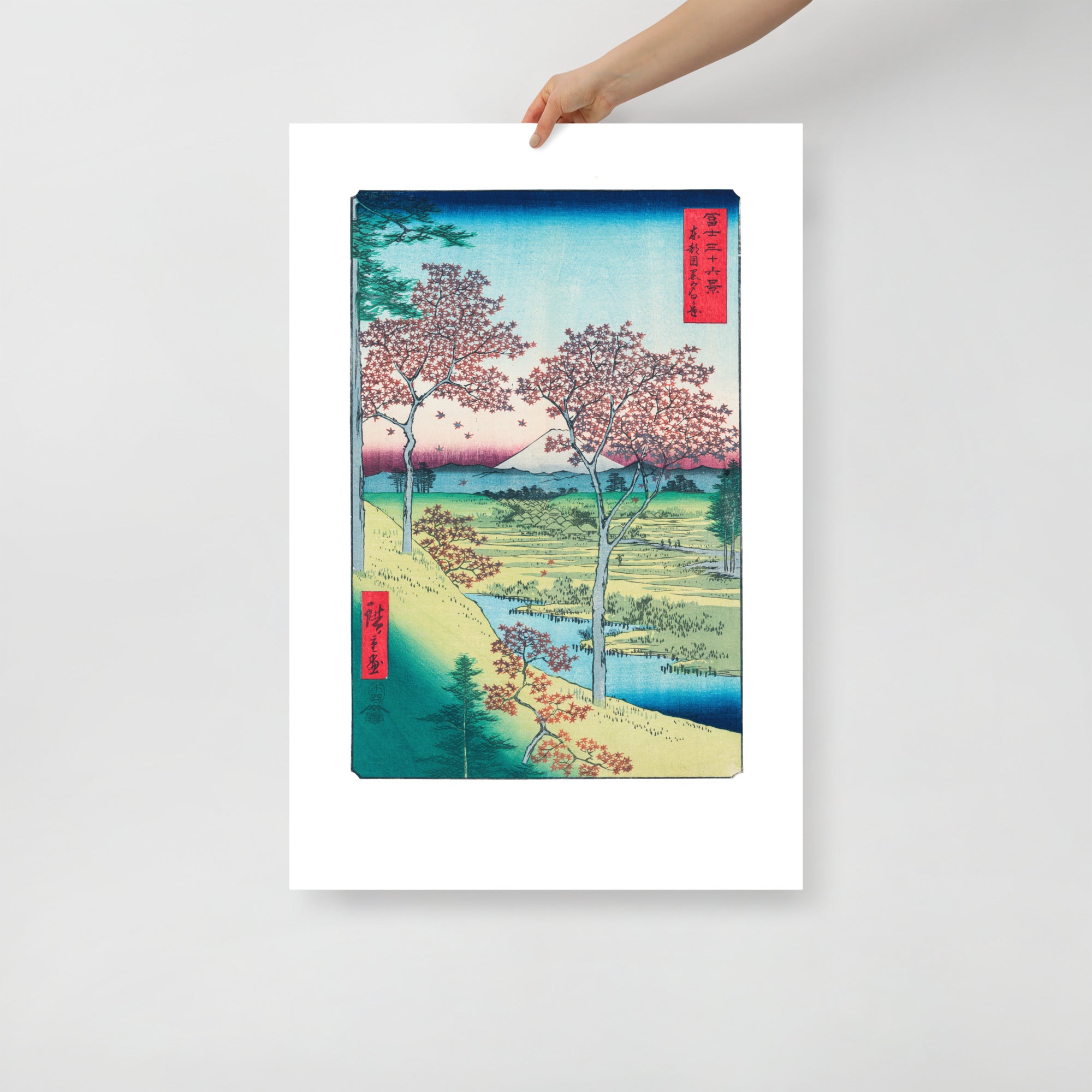 Close-up of textured woodgrain and vibrant sunset hues highlighting detailed maple leaves on Hiroshige's Sunset Hill print