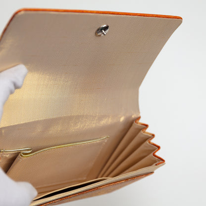 View inside the vintage Japanese clucth bag showing gold lining silk, internal pocket with gold trim and metal fastener.