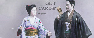 Vintage photo of japanese couple with text showing the man say gift cards and the woman sayig yes please linking to the gift card collection.
