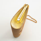 Close-up of intricate gold embroidery and textured silk weave on the vintage Japanese kimono clutch’s front flap, circa