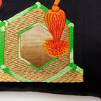 Close-up of gold and black geometric pattern on vintage Obi silk pillow fabric, highlighting intricate texture and fine