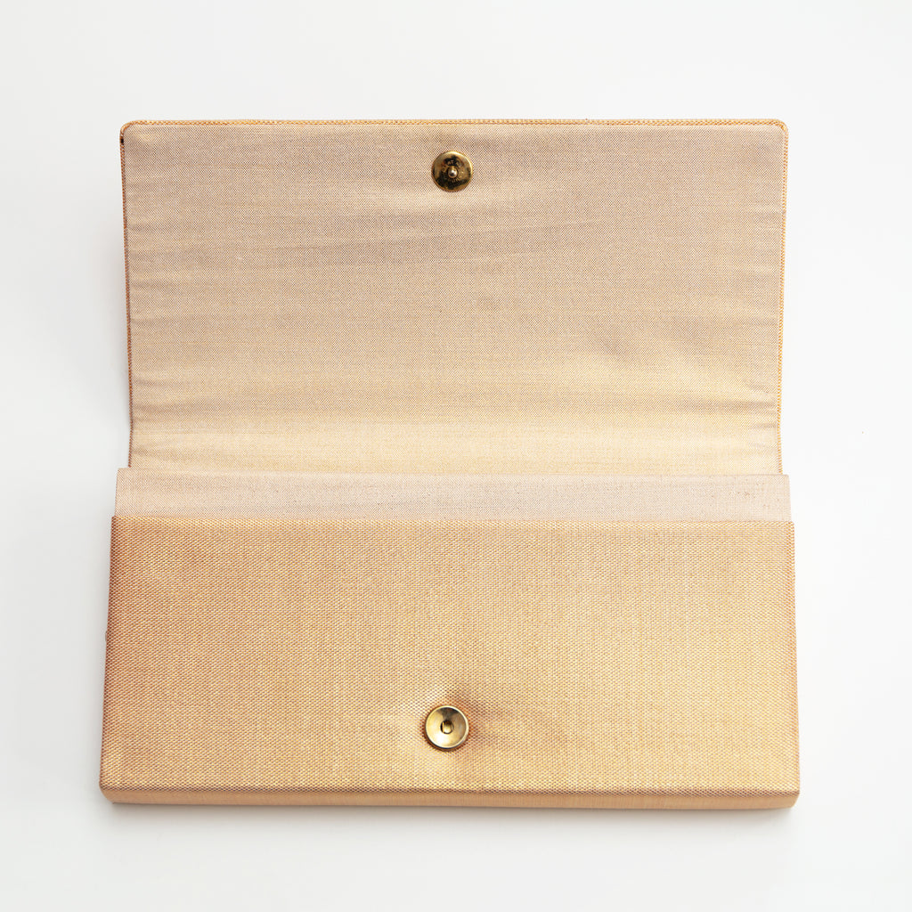 Close-up of vibrant orange fan patterns and intricate gold silk embroidery on the vintage Japanese handbag's corner detail.