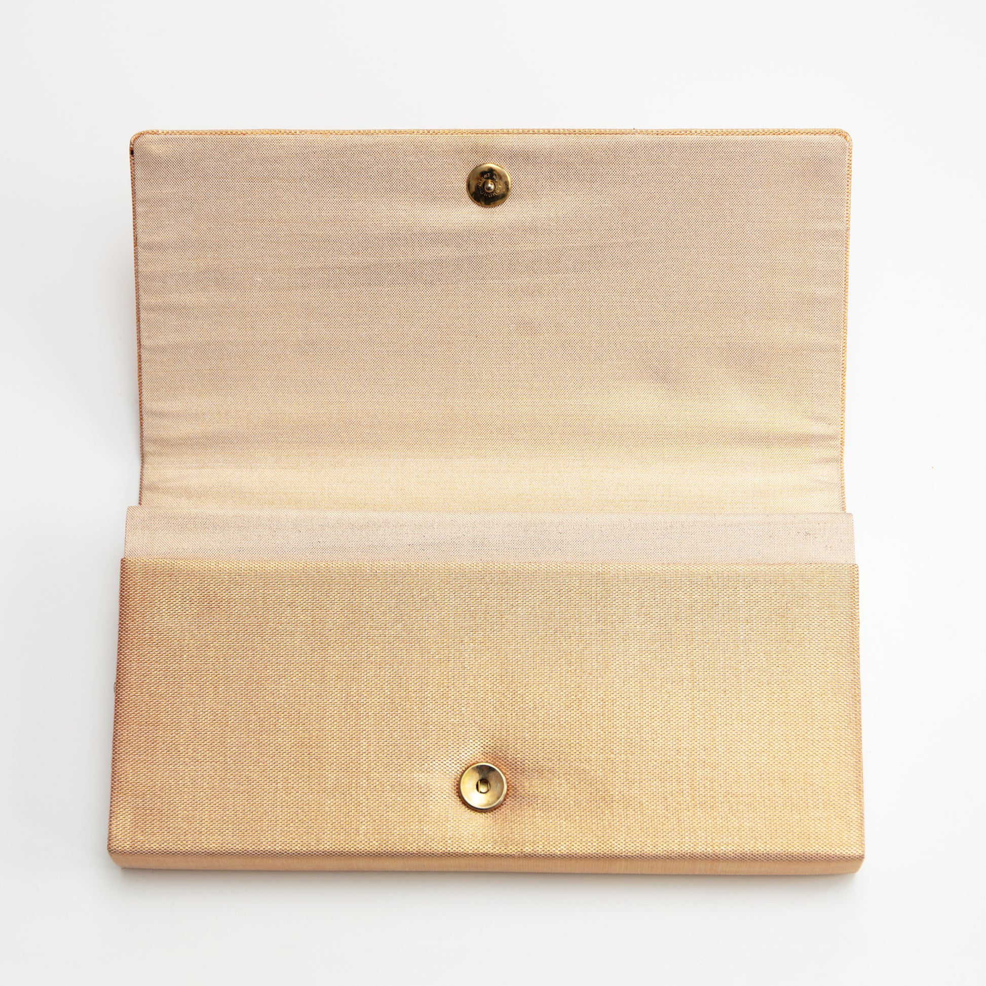 Metallic gold woven silk envelope clutch with gold stud closure on a white background