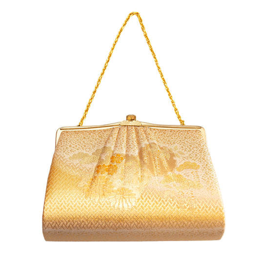 Gold handbag with floral embroidery on a white background