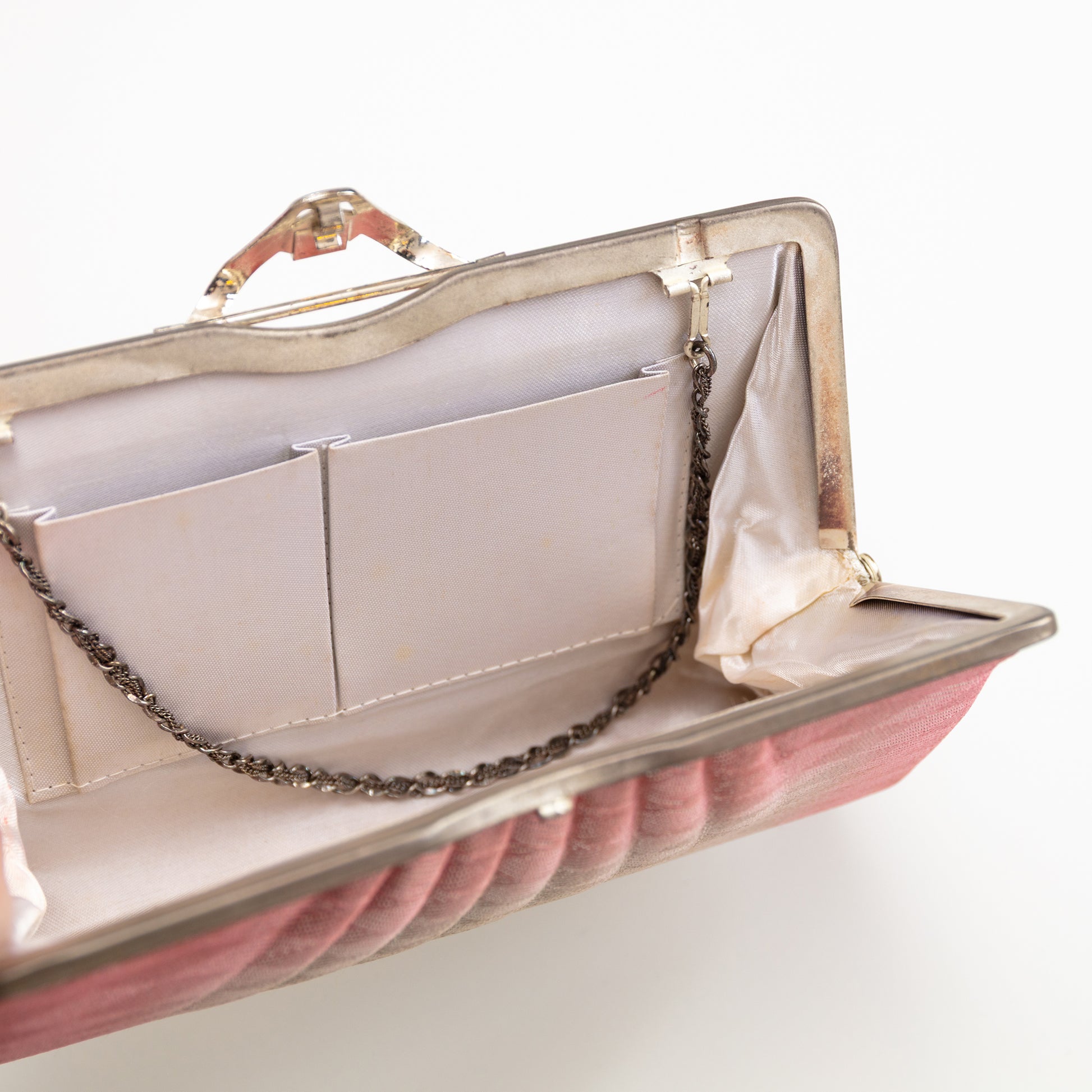 Pink vintage Japanese clutch bag with a chain detail on a white background