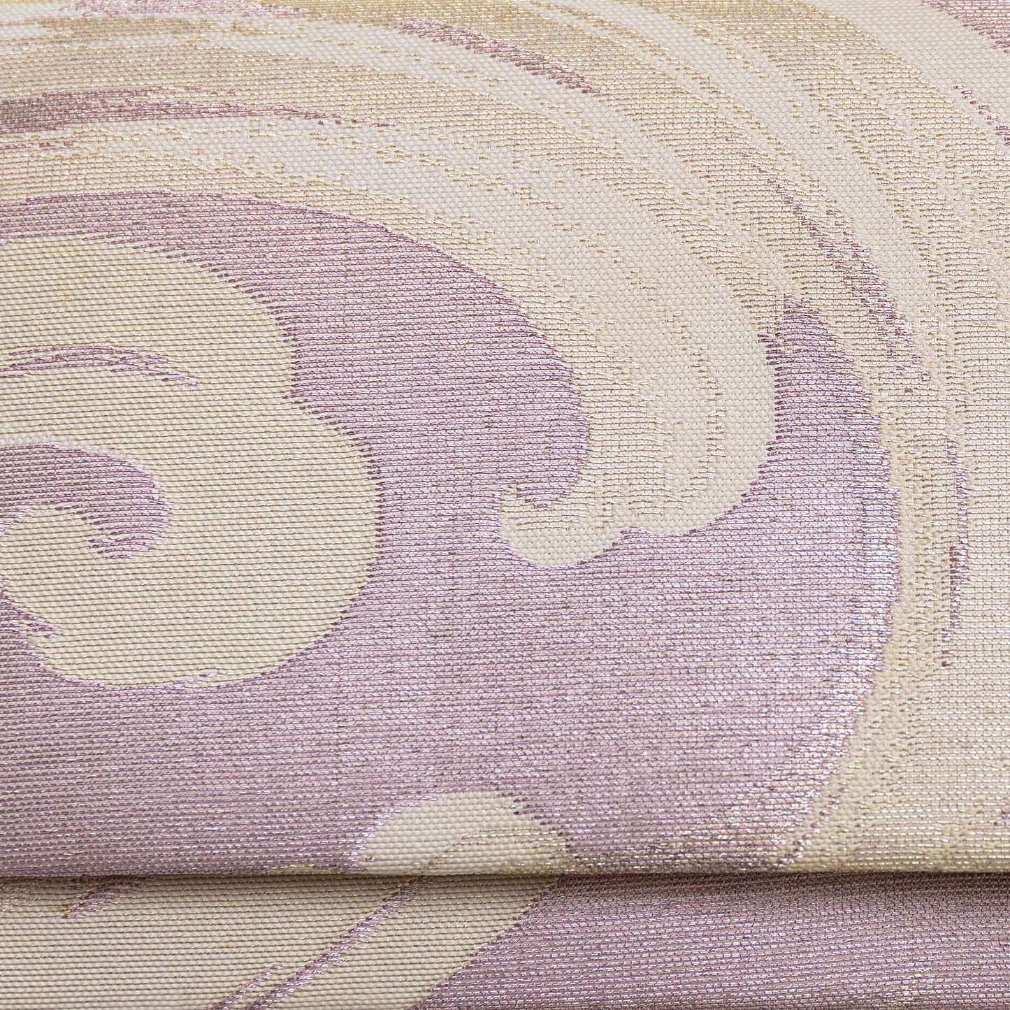 Close up detail of the front of the pink lilac clutch bag. Woven metallic brocade with cream and silver threads in a wild wave pattern.