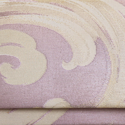 Close up detail of the front of the pink lilac clutch bag. Woven metallic brocade with cream and silver threads in a wild wave pattern.