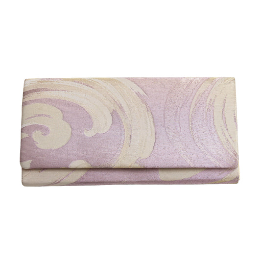 Lilac silk clutch bag with cream wave design on white background.