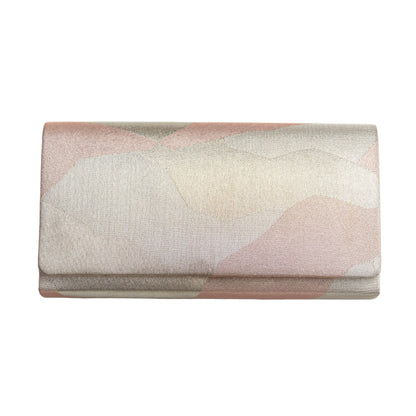 Abstract-patterned metallic silver and pink clutch bag on a white background