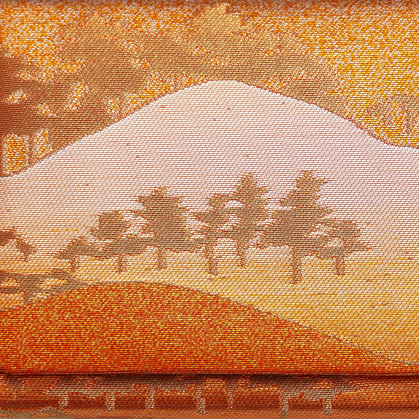 Metallic gold, bronze and orange brocade silk showing mountains and trees in a scenic landscape. Design on front of the vintage Japanese clutch bag.