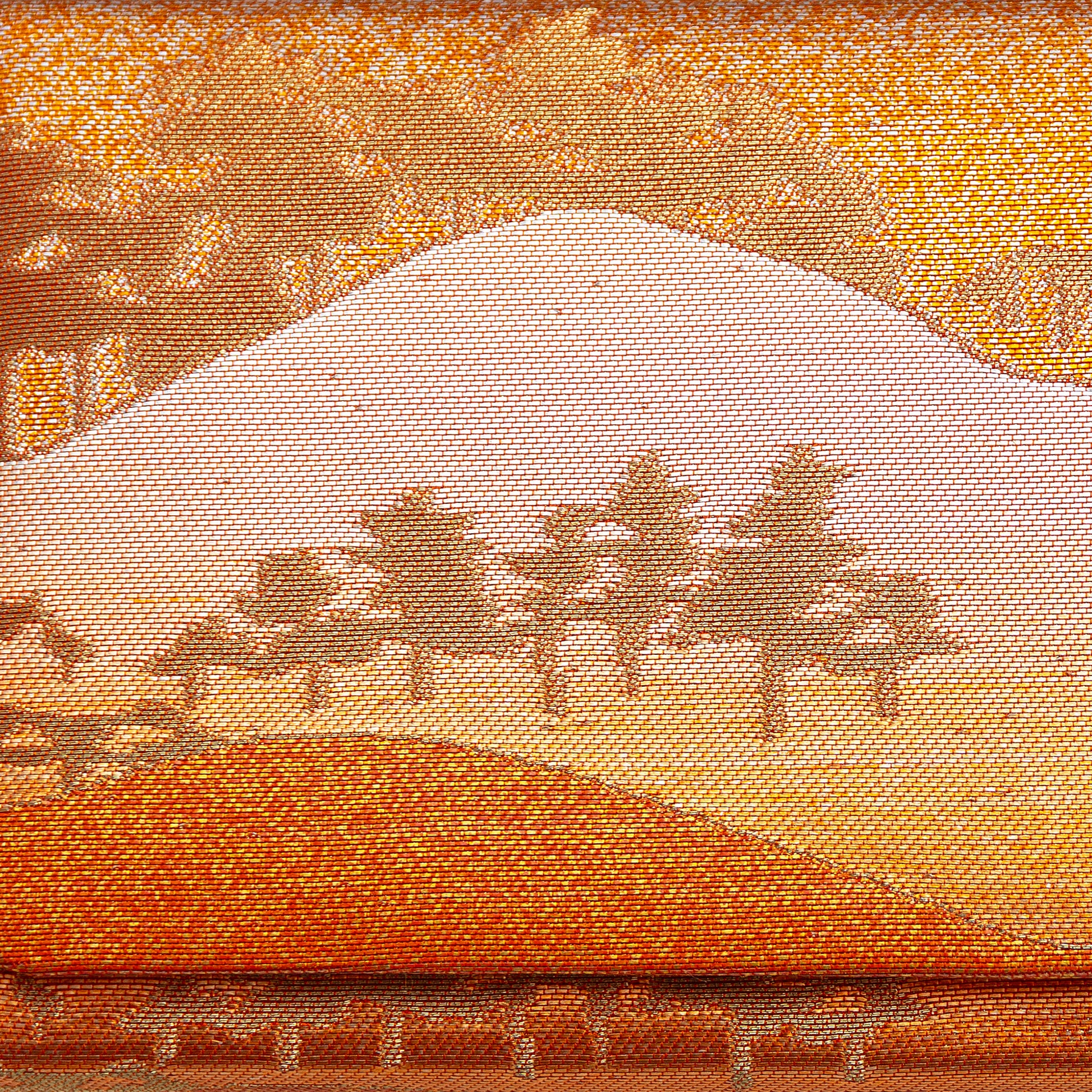 Metallic gold, bronze and orange brocade silk showing mountains and trees in a scenic landscape. Design on front of the vintage Japanese clutch bag.