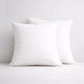 Set of two square feather cushion inserts with cotton cambric covers