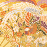 Detail of the central panel of the cushion showing a flying phoenix and flowers in woven gold, purple and orange silk.